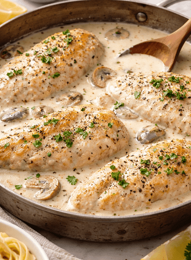Bowl of creamy white chicken chilli topped with herbs and served warm.