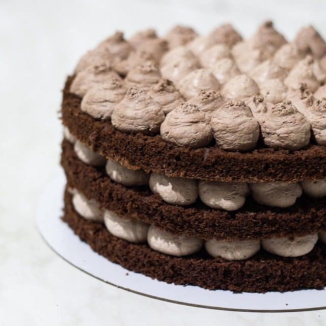 Cocoa powder, flour, eggs, butter, and chocolate ready for Chocolate Cake Recipe