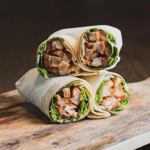 Juicy chicken shawarma wrap served with garlic sauce and fries